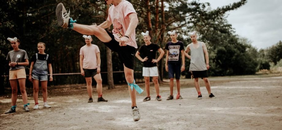A group of people enjoying an outdoor game with fun eye covers and energetic movements.